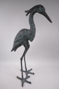 A patinated metal garden figure of a heron, 27" high