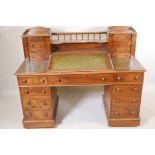 A Victorian walnut twin pedestal Dickens desk, with a three section tooled leather inset top, the
