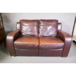 A brown leather two seater club sofa, 63" wide, 35" high