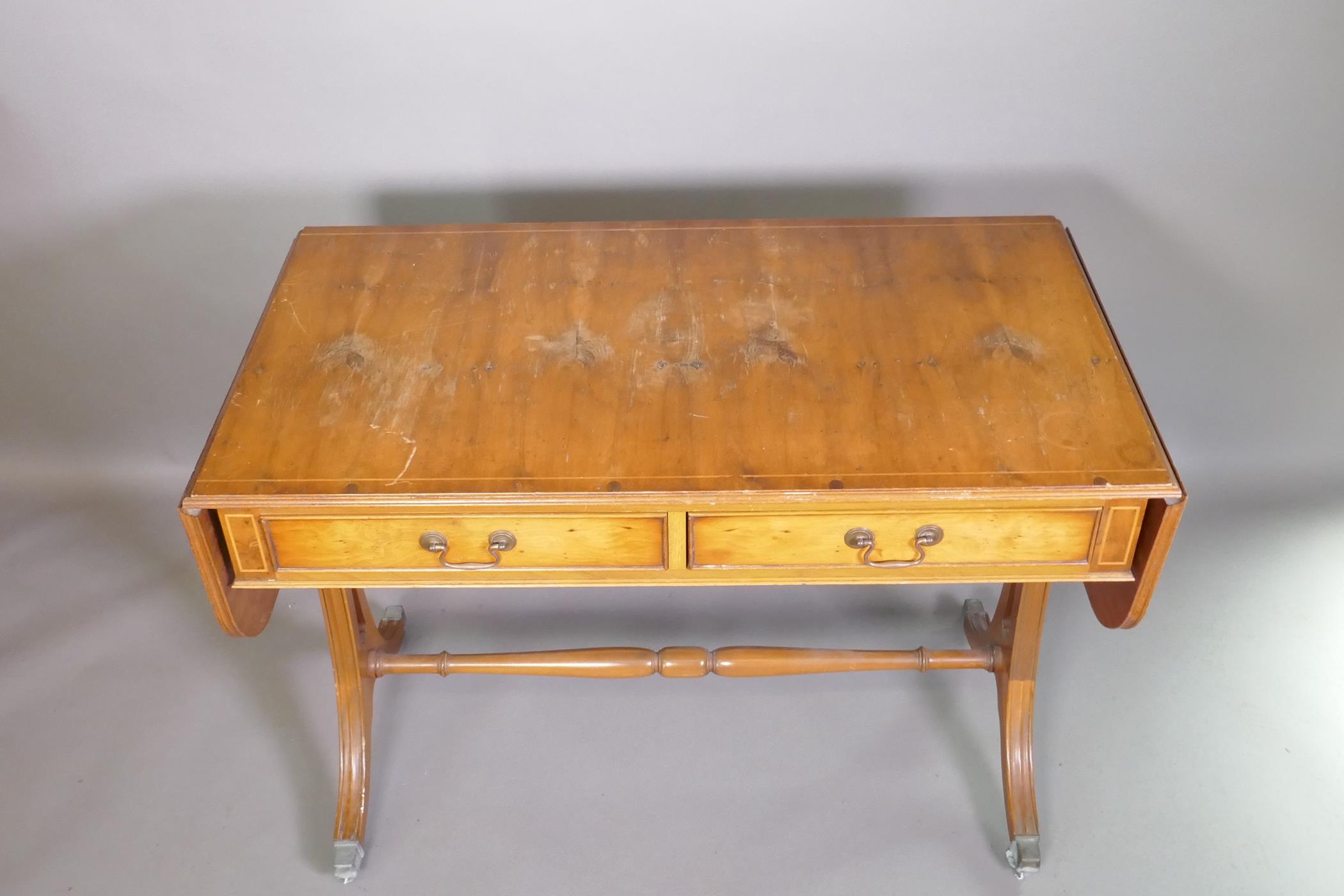 A Regency style yew wood veneered sofa table with two drawers, raised on pierced shaped ends with - Image 3 of 3