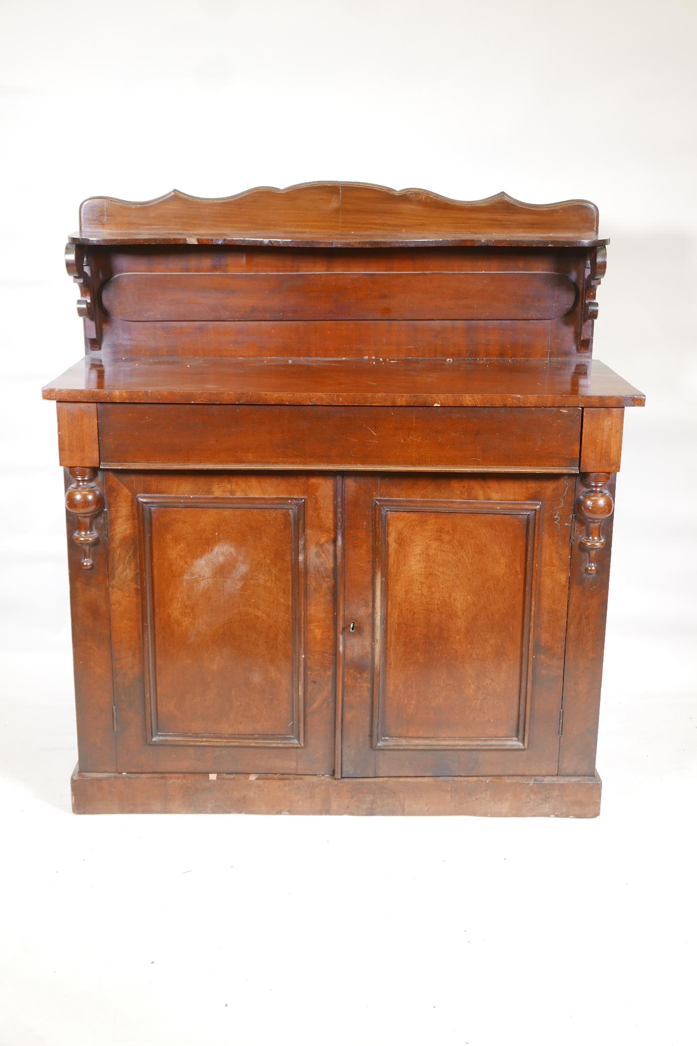 A Victorian mahogany chiffonier, with shaped back and single frieze drawer over two cupboards,