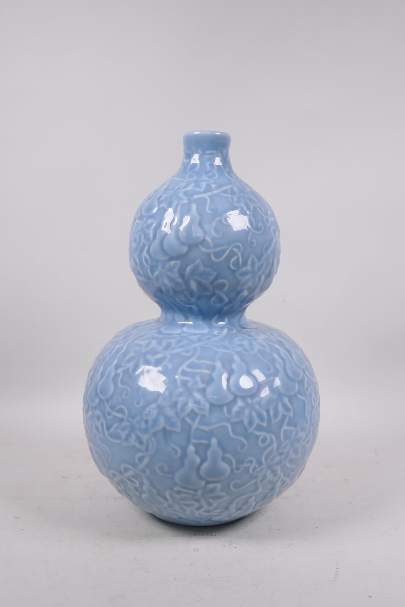 A Chinese light blue glazed porcelain double gourd vase with raised all over gourd vine - Image 3 of 5