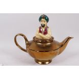 A Wade Pottery 'The Genie' teapot with gold resist glazed body and painted figurine