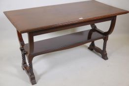 A C19th mahogany two tier Arts and Crafts centre table, raised on shaped end supports with pegged