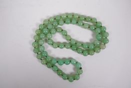 A Chinese jade bead necklace, 33" long