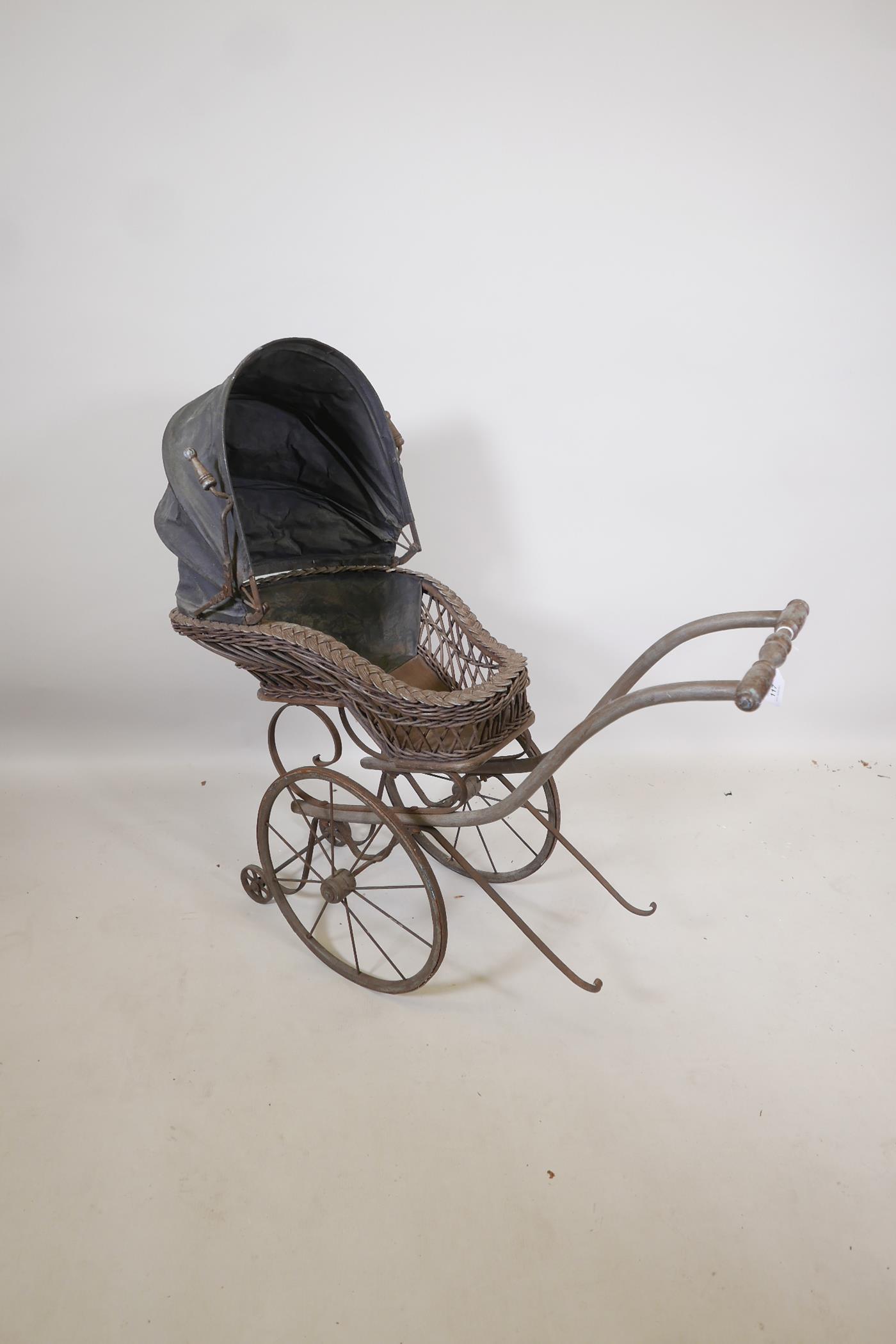 A Victorian wood framed and cane child's pram, 38" x 15" x 35" high