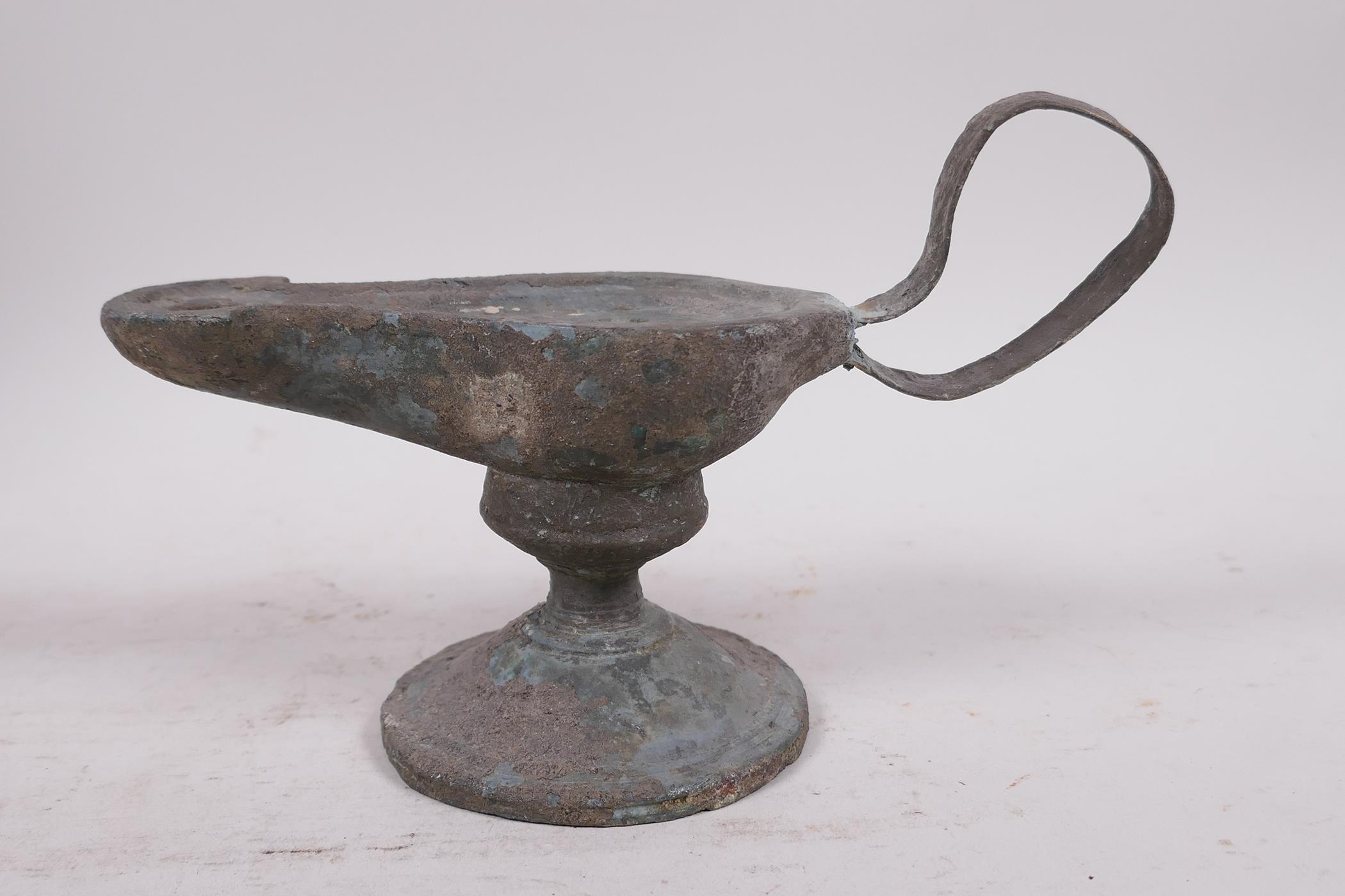 A Roman bronze oil lamp on pedestal base, 7" long - Image 2 of 4