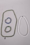 A green hardstone beaded necklace, a white ceramic beaded necklace, and two cloisonne bracelets,