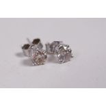 A pair of 14ct white gold diamond stud earrings, approximately 62 points