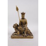 A Chinese filled metal Buddha seated on a temple lion, 4 character mark to base, 8½" high