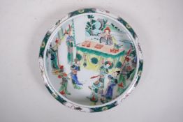 A Chinese famille verte porcelain dish with a rolled rim, decorated with a court scene, Kangxi 6