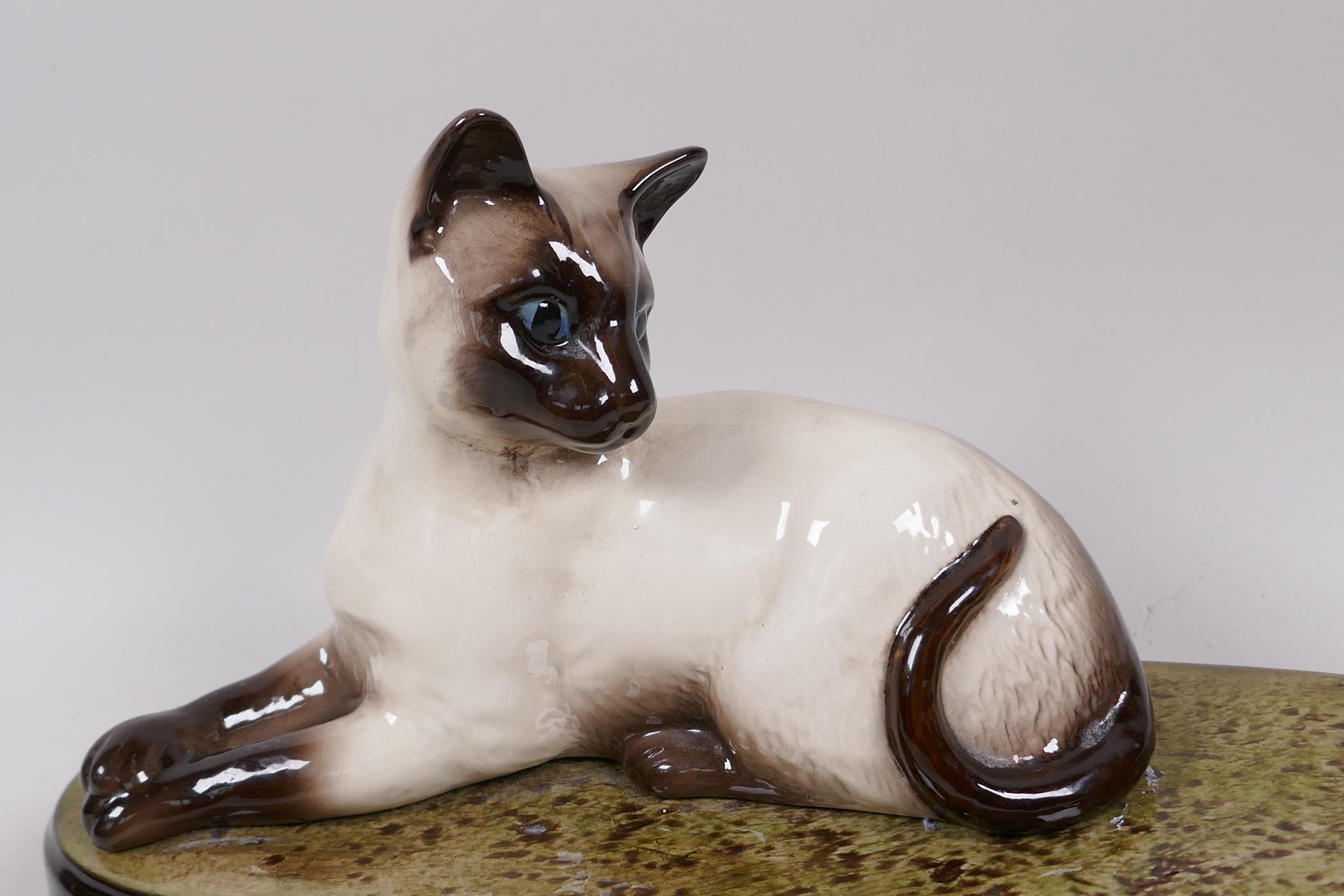 A Beswick figure of a Siamese cat, on a grassy plinth, 11½" long - Image 2 of 3