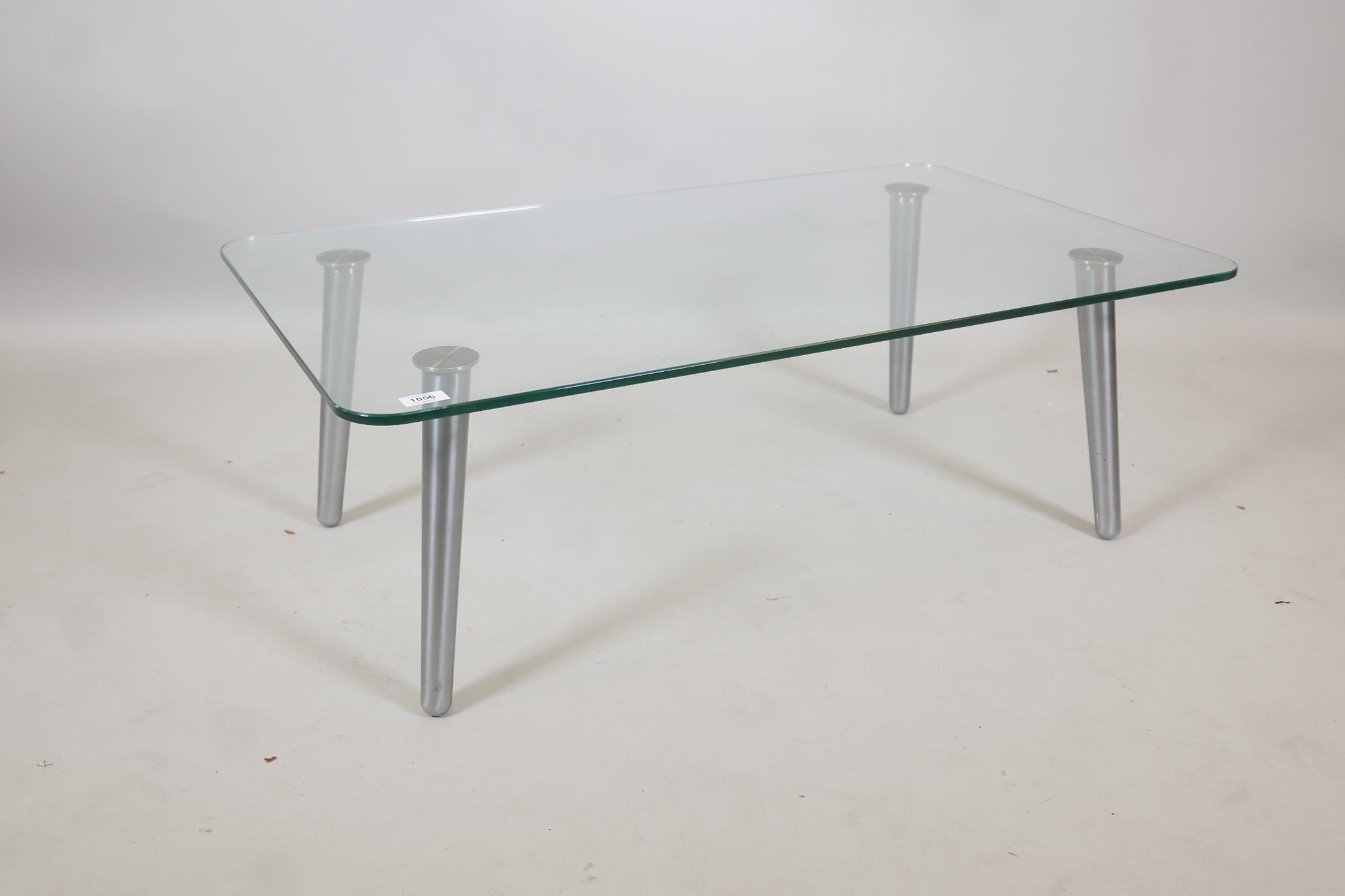 A contemporary glass and brushed steel coffee table, 39½" x 24" x 13"