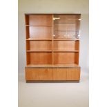 A G-Plan teak modular display cabinet in four sections, the upper glazed and open shelves, the lower