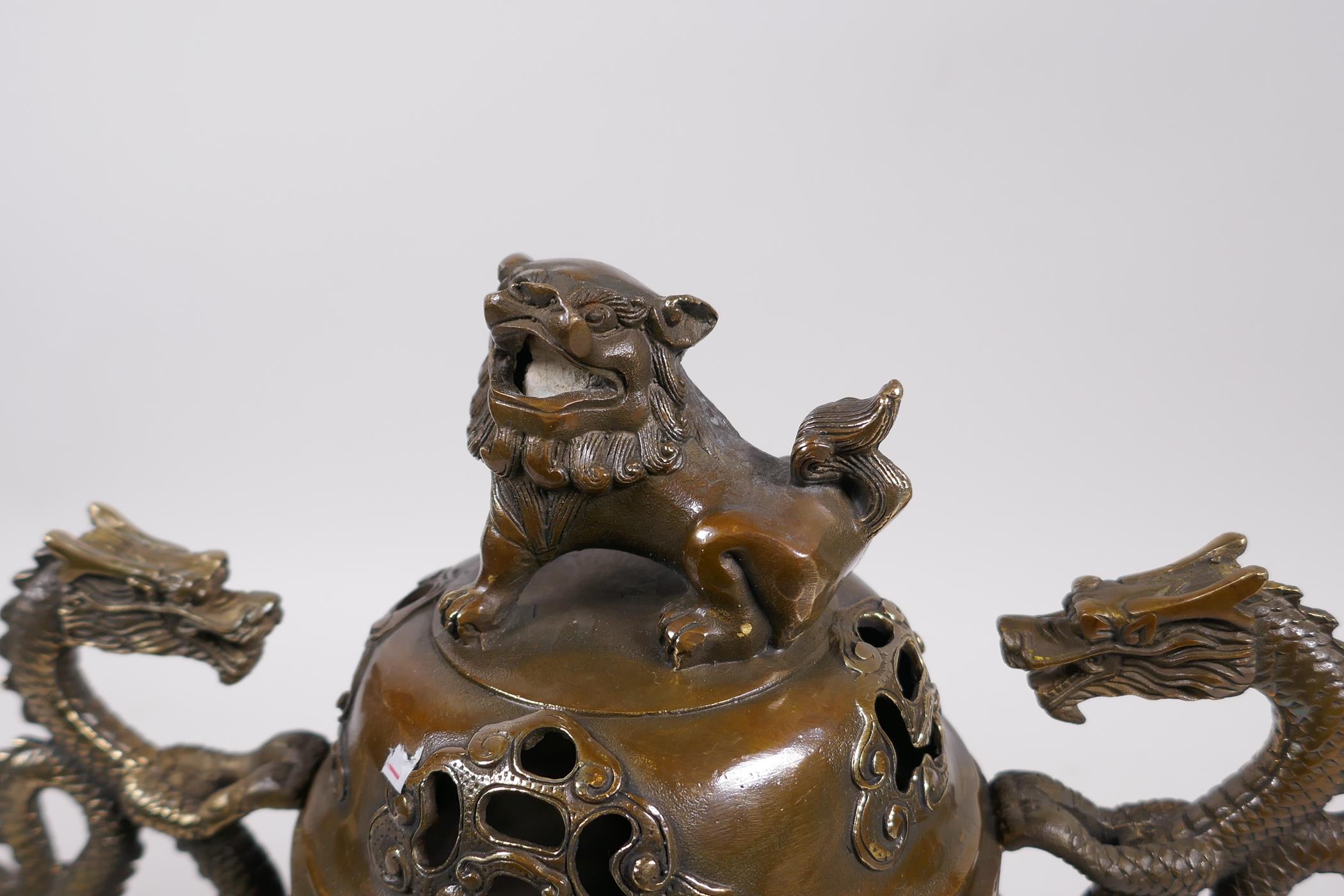 A Bronze Chinese dragon censer and cover with two handles and a fo dog knop, raised on tripod - Image 2 of 6