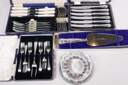 A boxed set of six tea knives with hallmarked silver handles, a box of cake forks from J. Dixon, a