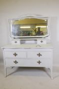 An Edwardian painted dressing table, with carved details, the mirrored top section with two drawers,