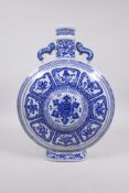 A blue and white porcelain two handled moon flask decorated with the eight Buddhist symbols,