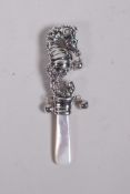 A sterling silver baby's rattle in the form of a seahorse, with a mother of pearl style handle,