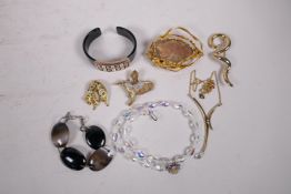 A collection of assorted costume jewellery to include bangles, brooches, necklaces etc