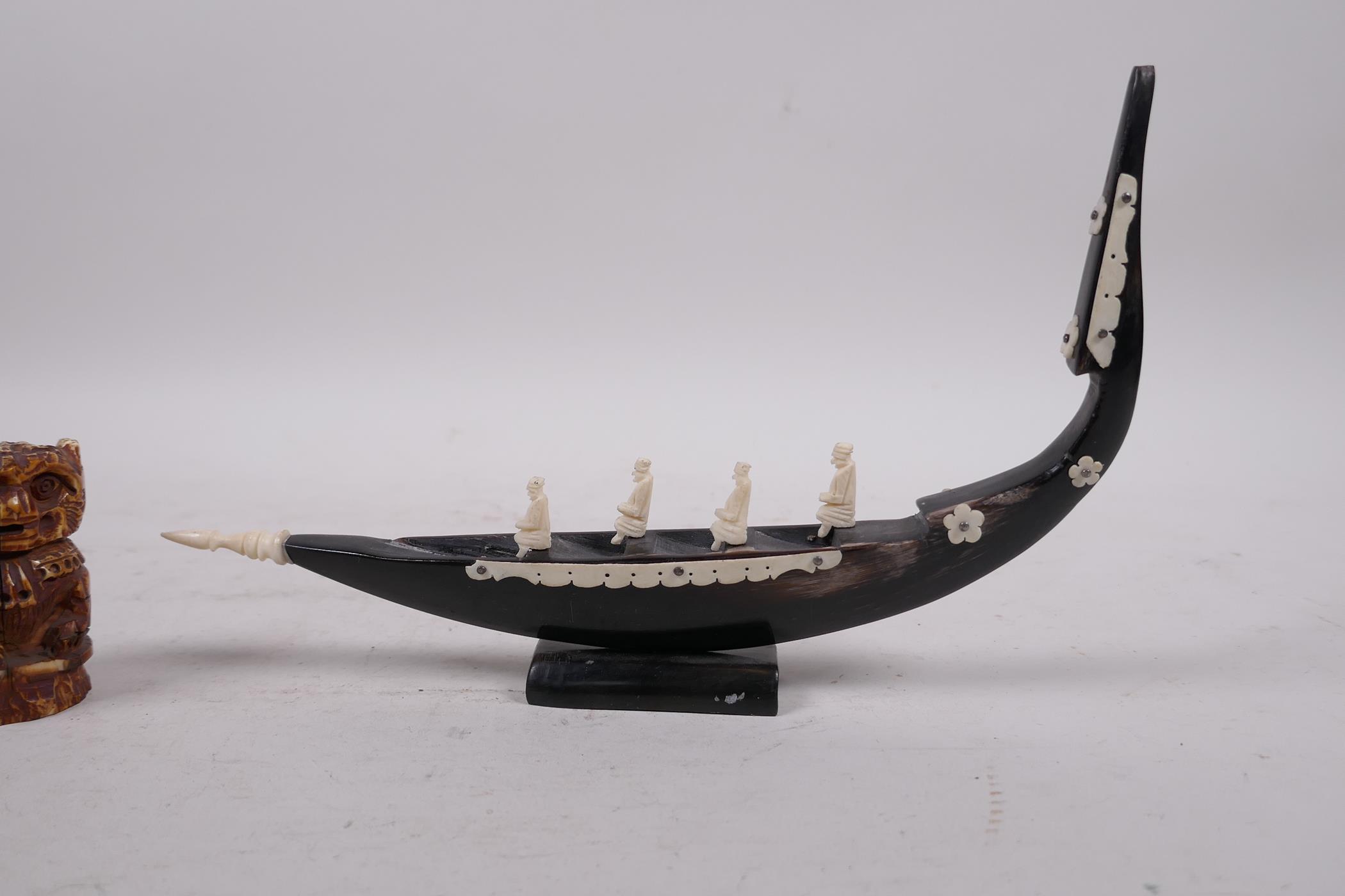 An Indian bone and horn carving of a boat, and a bone carving of a monkey, largest 9" long - Image 2 of 5