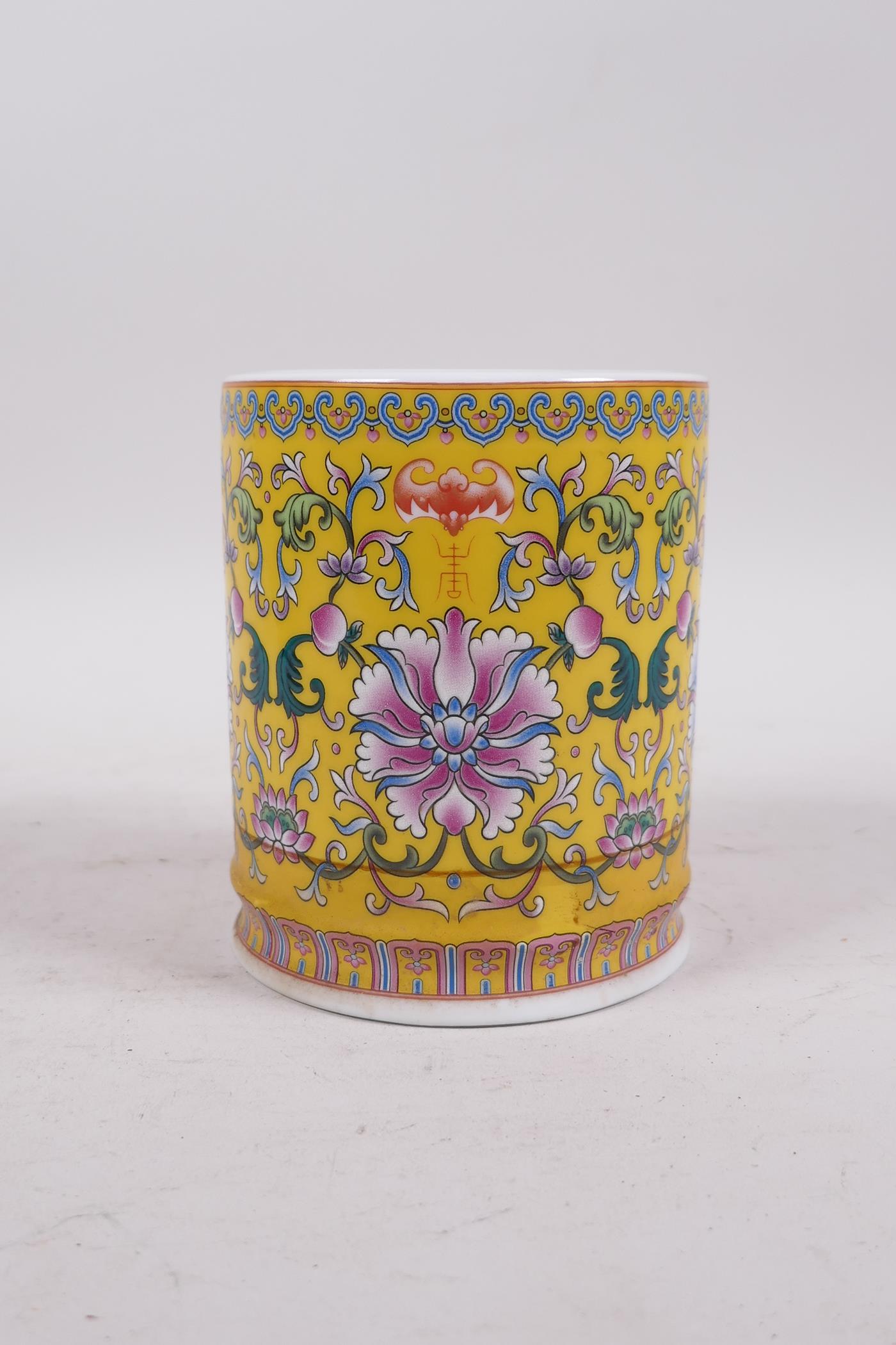 A Chinese yellow ground porcelain brush pot with polychrome lotus flower decoration, seal mark to - Image 2 of 5