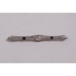 An Art Deco 14ct white gold brooch set with sapphires and a diamond, 2½" long