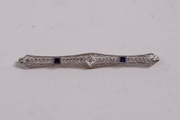 An Art Deco 14ct white gold brooch set with sapphires and a diamond, 2½" long