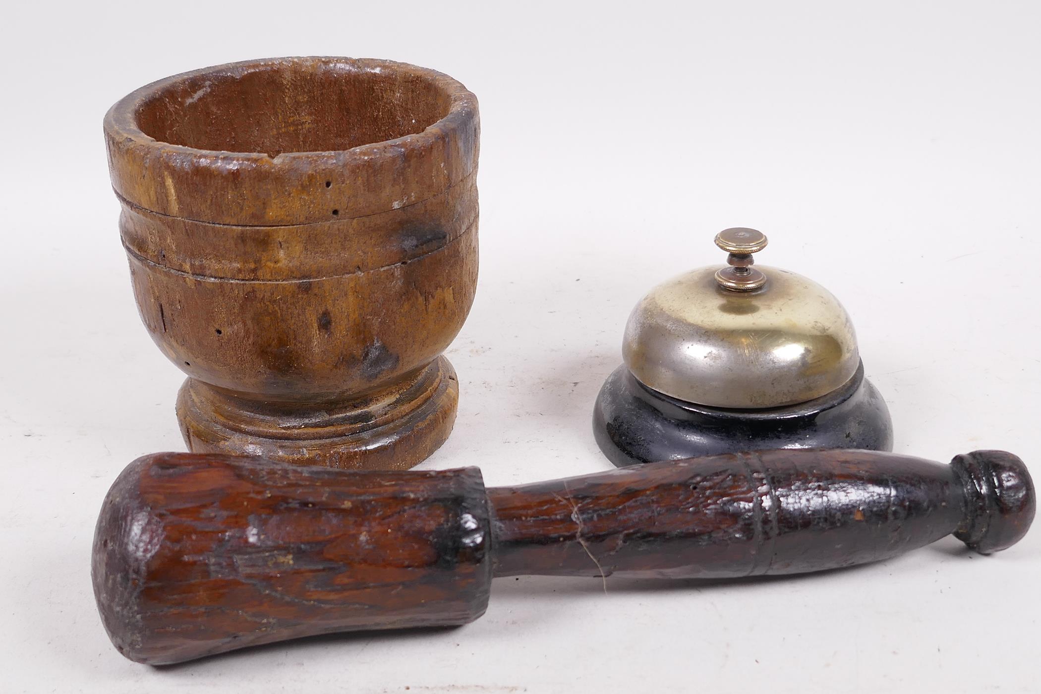 An antique French wooden mortar and pestle, mortar 4" high, and a reception desk bell