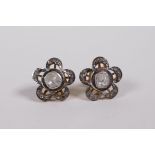 A pair of silver gilt and uncut diamond ears studs in the form of flowers