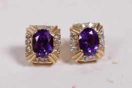 A pair of amethyst and diamond earrings set in 14ct mounts