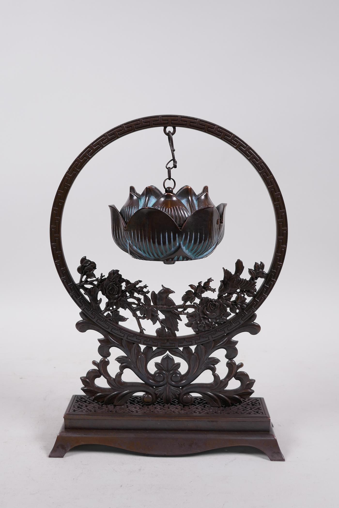 An Oriental bronze hanging incense burner in the form of a lotus flower, 10" high