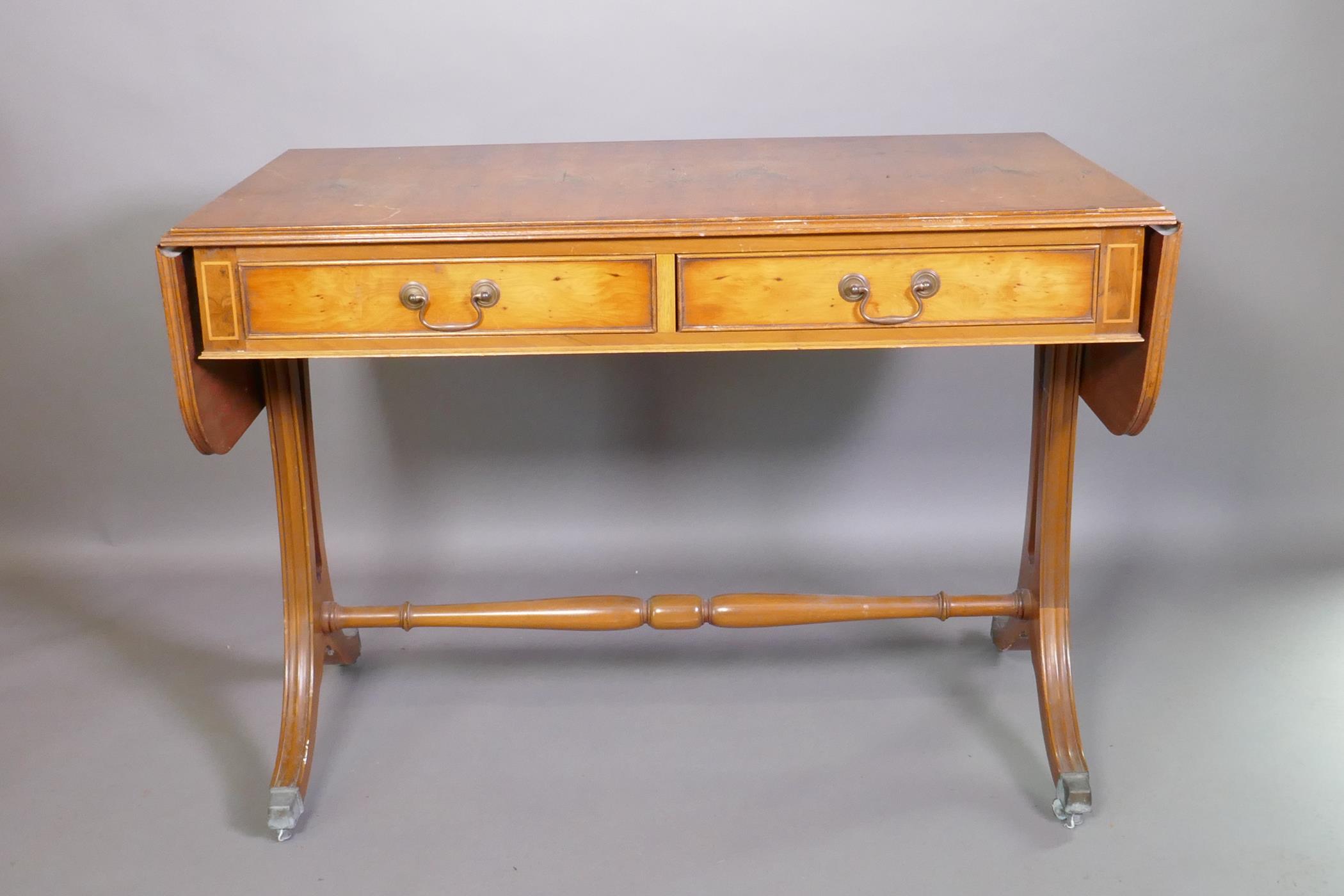 A Regency style yew wood veneered sofa table with two drawers, raised on pierced shaped ends with - Image 2 of 3