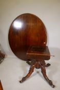 A Victorian mahogany tilt top breakfast table raised on a shaped column and four cabriole