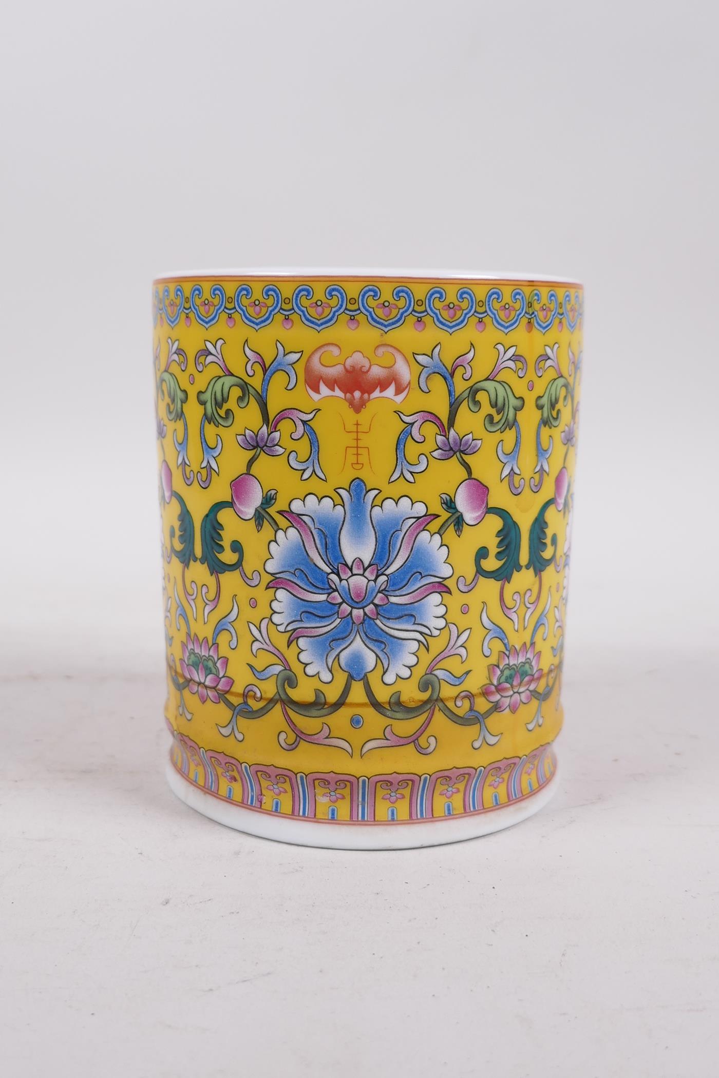 A Chinese yellow ground porcelain brush pot with polychrome lotus flower decoration, seal mark to - Image 3 of 5