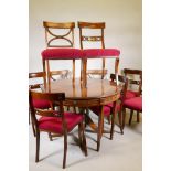 A mahogany drawleaf dining table with dummy drawer frieze, raised on a turned column and splay feet,
