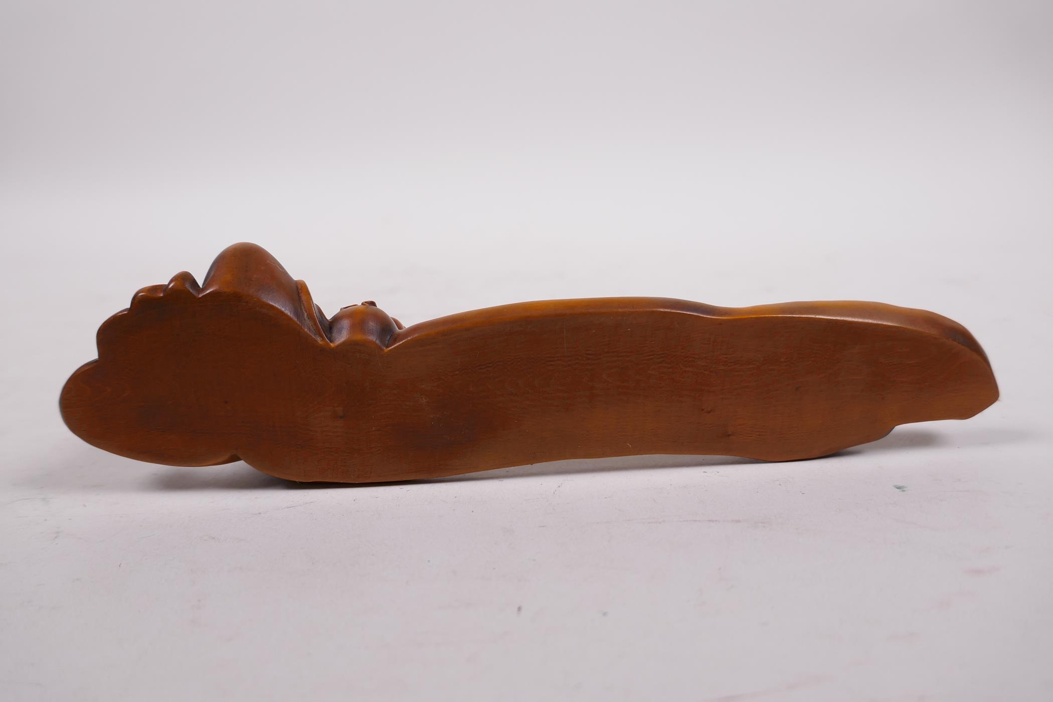 A Chinese carved boxwood incense stick holder in the form of a reclining sage, 7½" long - Image 3 of 3