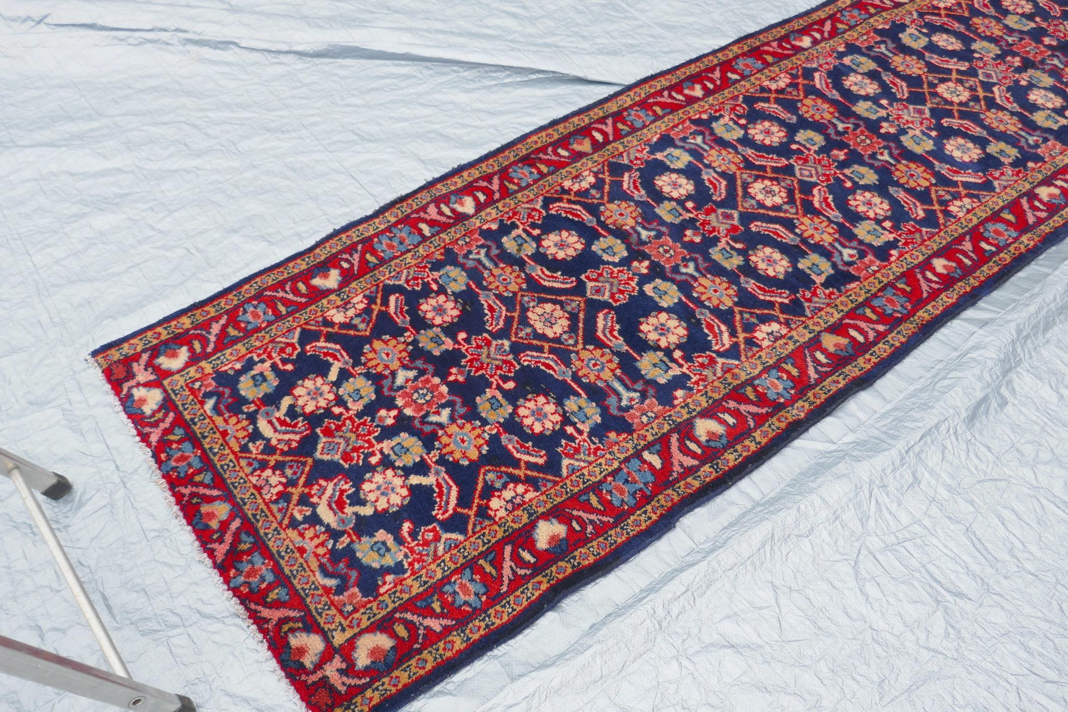 A blue ground Persian Sarouk runner with all over design and red borders, 33" x 140" - Image 3 of 8