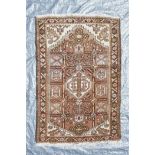 A Persian brown and cream ground wool prayer rug, with a geometric medallion design, 50" x 34"
