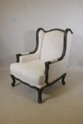 A contemporary wingback armchair, the frame with distressed paint finish, retailed by 'The One', 43"