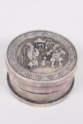 A Chinese circular white metal ink box, the cover decorated with figures, 1¾" diameter