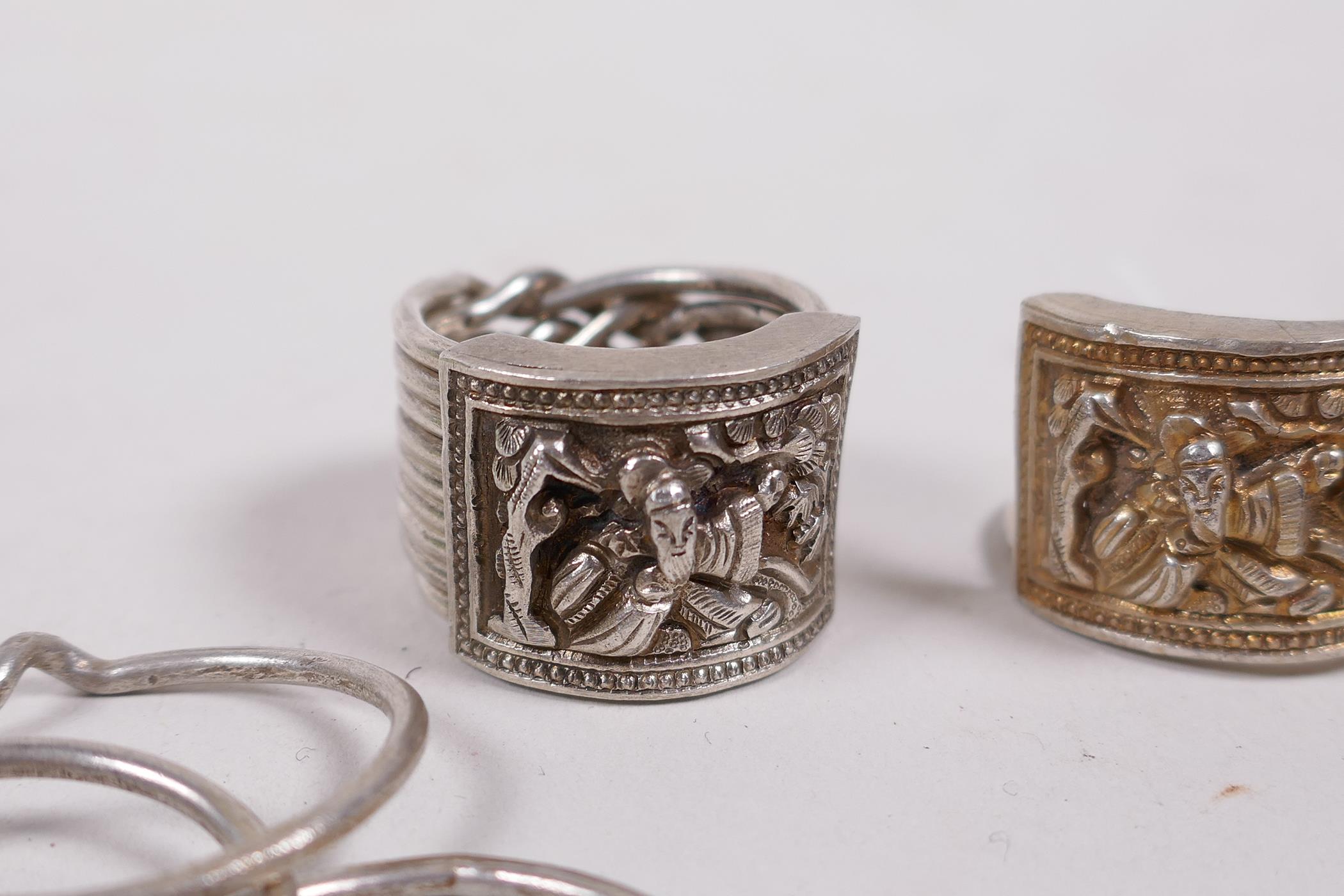 Two Chinese white metal nine link rings, with repousse decoration of a sage - Image 2 of 4