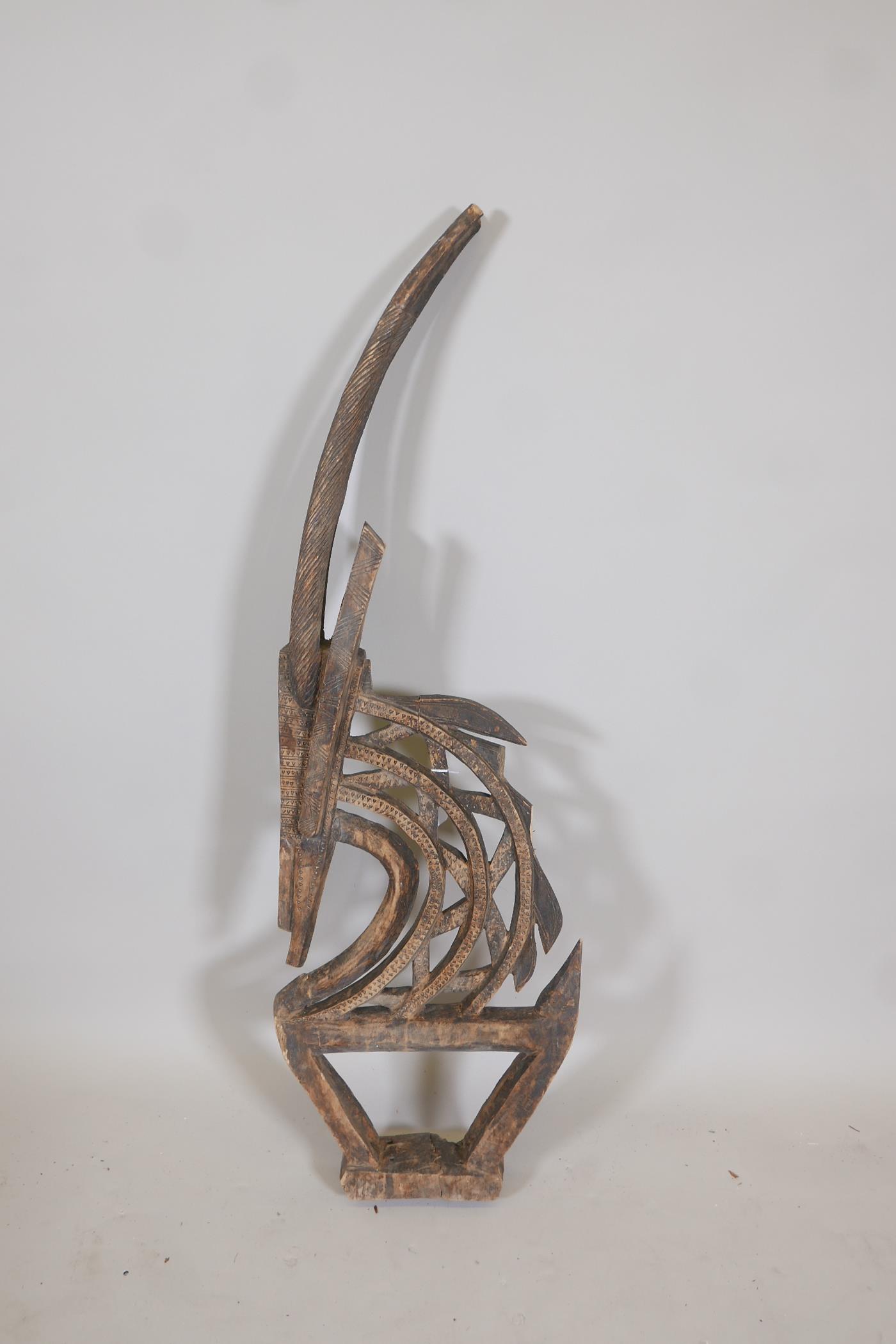 An African carved wood stylised figure of a antelope, A/F, 44" high - Image 2 of 4