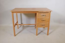 A light oak utilitarian three drawer desk with a stationary slide, 42" x 24", 30" high