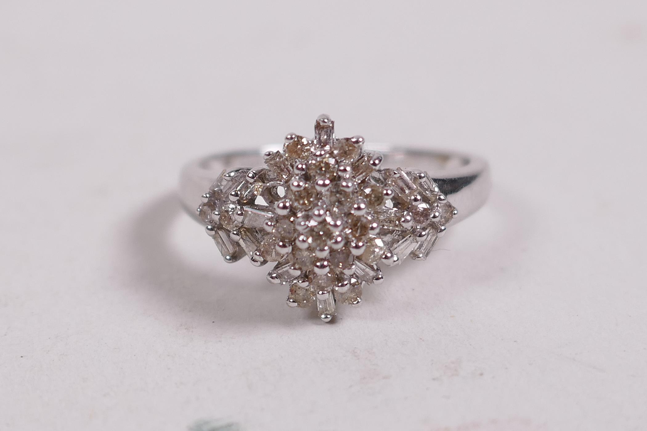 A 9ct white gold and diamond set cluster ring in the Art Deco style, approximate size 'M'