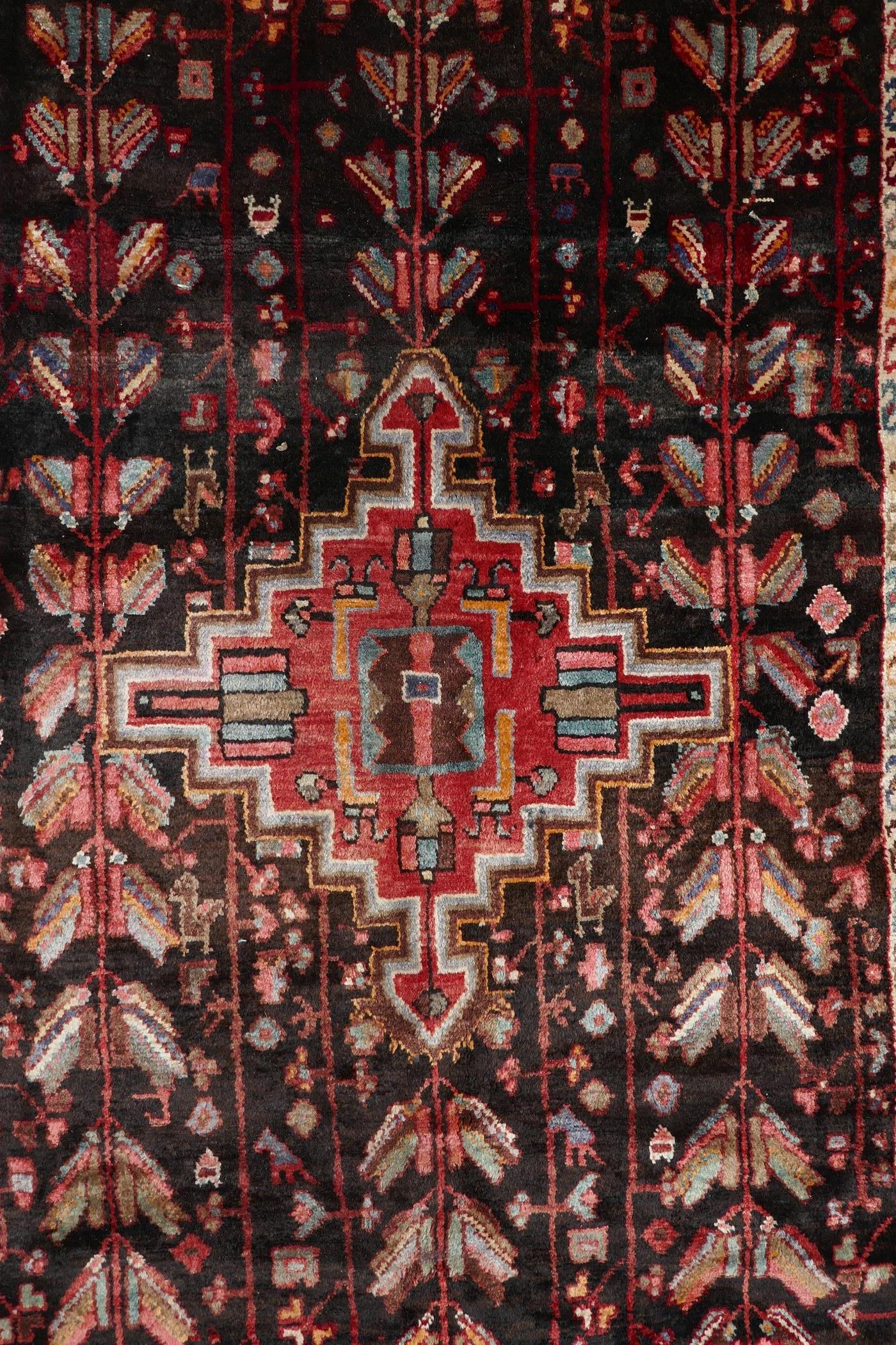 A multicoloured ground Iranian village rug with a bespoke all over design, 116" x 55"