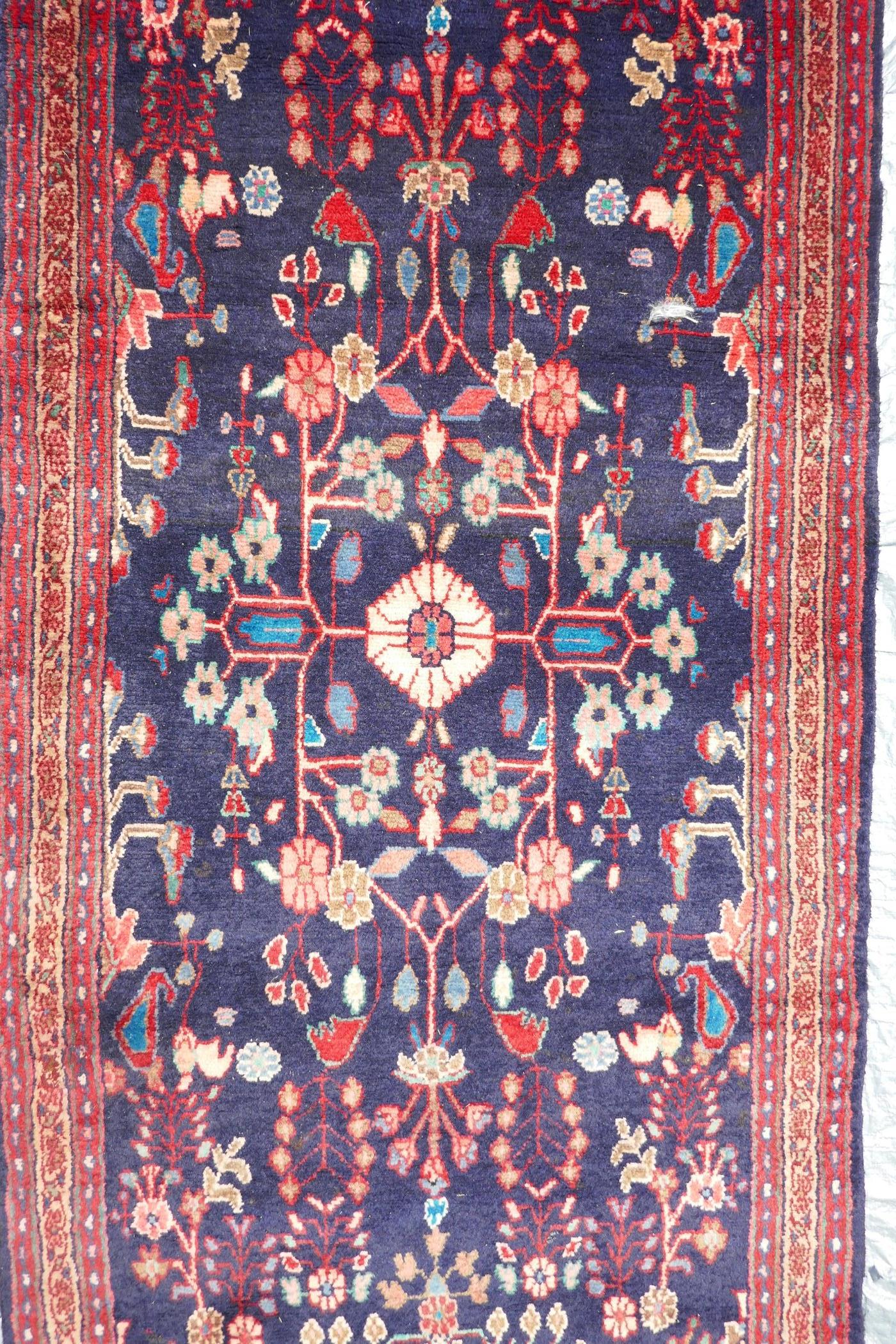 A rich blue ground full pile Persian Sarouk runner with an unique floral pattern, 122" x 41"
