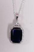 A 925 silver and large faux sapphire pendant necklace encircled by cubic zirconium, 1½" drop