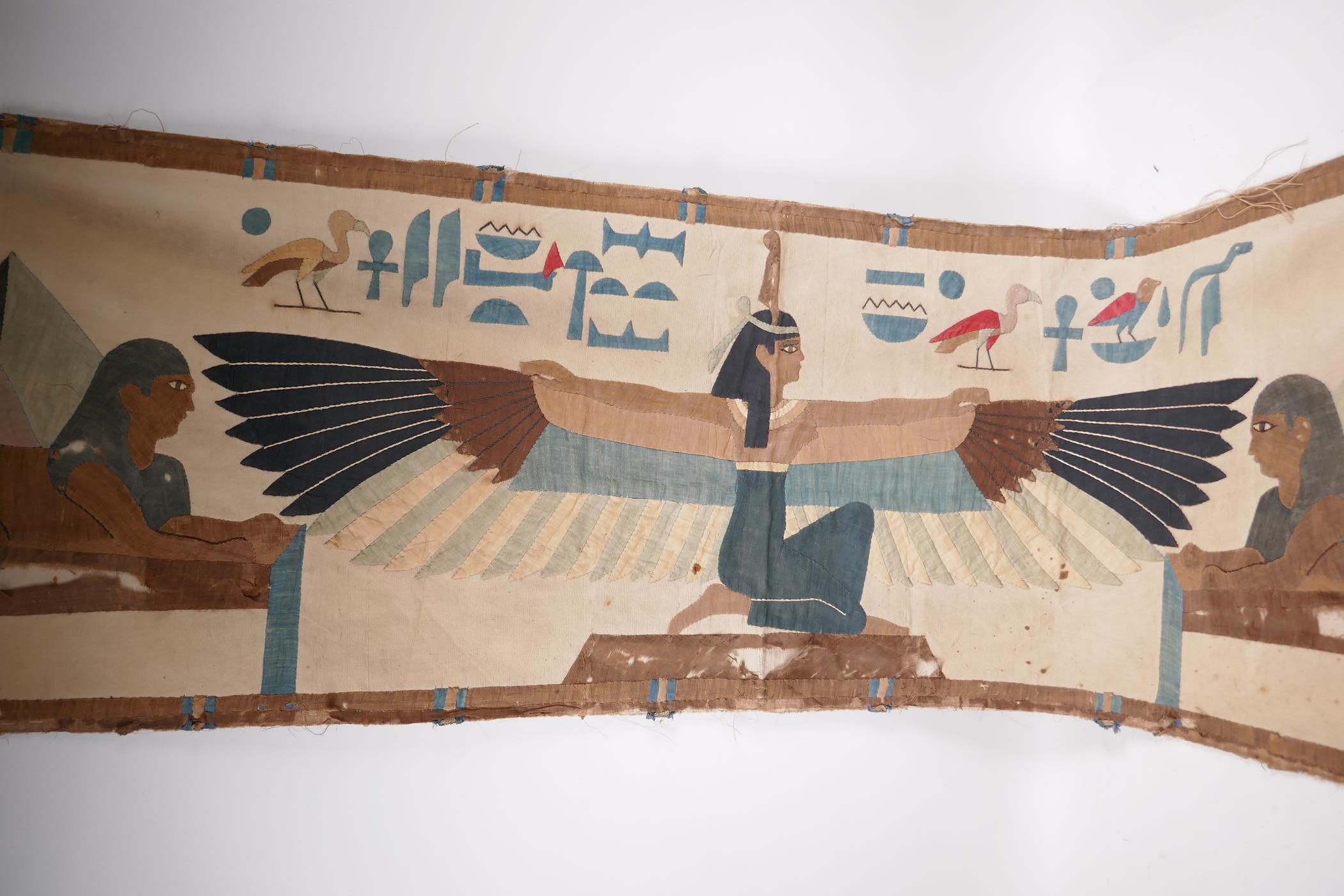 An Egyptian revival wall hanging depicting a winged deity and two sphinx, 57" x 18", A/F - Image 2 of 2