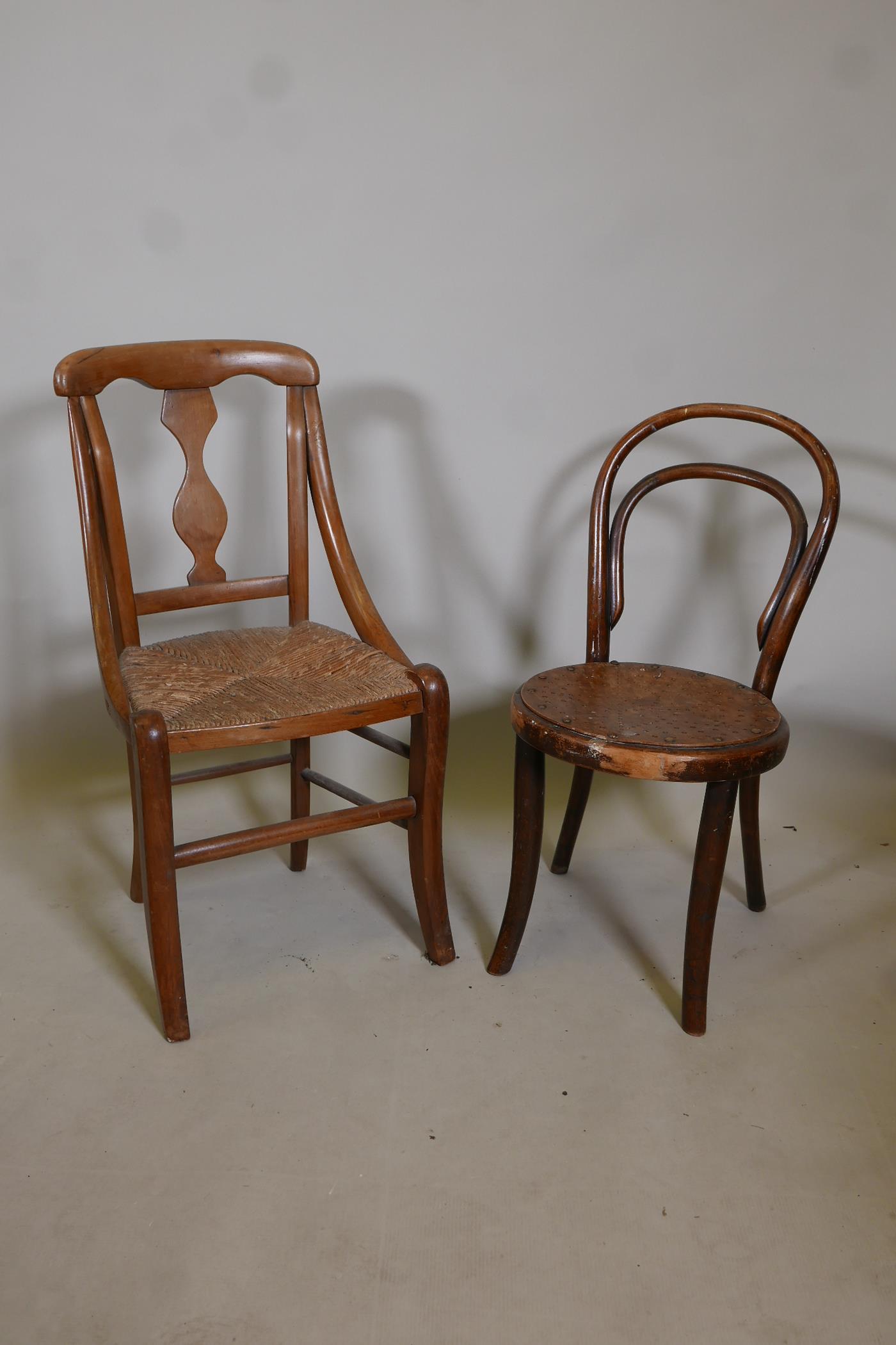 A child's bentwood chair together with a child's fruitwood splat back chair with rush seat, 28" high